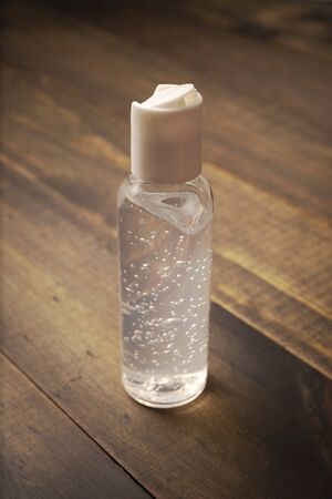 pocket hand sanitizer bottle on wooden background, useful for COVID19 pandemic conceptの写真素材