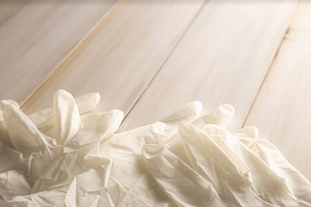 medical latex gloves for protection on wooden background. Useful for pandemic prevention conceptの写真素材