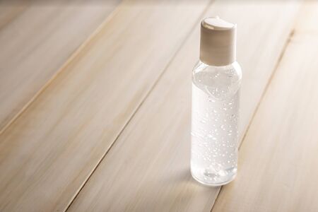 pocket hand sanitizer bottle on wooden background, useful for COVID19 pandemic conceptの写真素材