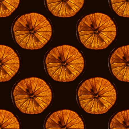 seamless pattern of slice orange fruit with backlight isolated on black background, can be tiledの写真素材