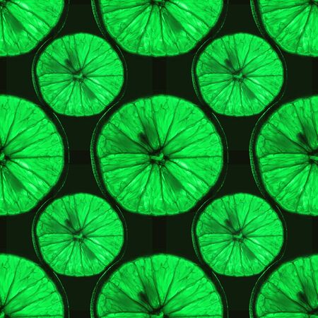 seamless pattern of slices of green citrus fruit with backlight isolated on black background, can be tiledの写真素材