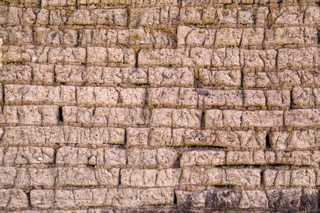 Old adobe bricks wall made of mud and straw. Useful for backgrounds and texture.の写真素材