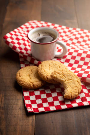 Homemade crunchy cookies and an espresso coffee cup on wooden tableの写真素材