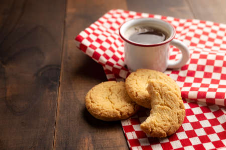 Homemade crunchy cookies and an espresso coffee cup on wooden rustic tableの写真素材