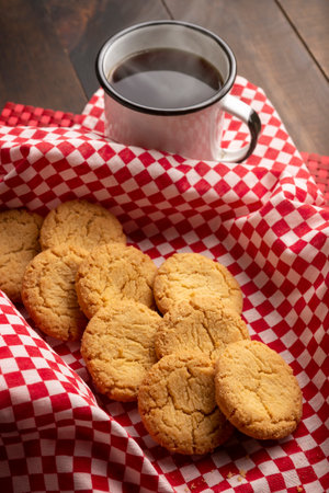 Homemade crunchy cookies and a coffee cup on wooden rustic tableの写真素材