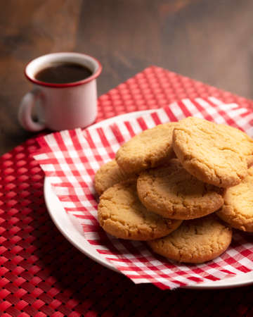 Homemade crunchy cookies and an espresso coffee cup on wooden tableの写真素材