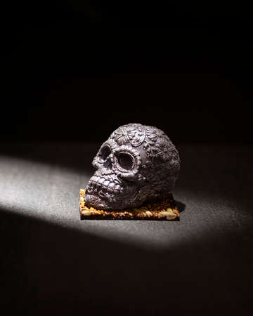 ornamented mexican skull made of gourmet chocolate, traditional gift for "dia de muertos" day of the death in Mexico culture named "calaverita de azucar" or "calaverita de chocolate"の写真素材