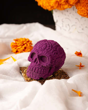 mexican skull made of chocolate. In Mexico culture named "calaverita de azucar" and Cempasuchil flowers or Marigold. Traditionally used in altars for the celebration of the day of the deathの写真素材
