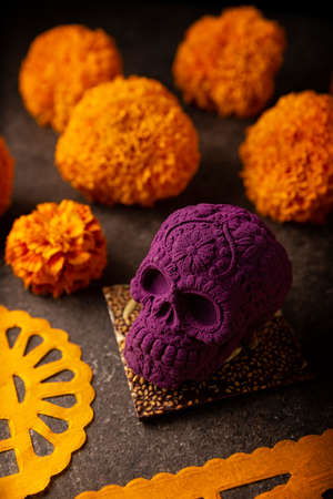 mexican skull made of chocolate. In Mexico culture named "calaverita de azucar" and Cempasuchil flowers or Marigold. Traditionally used in altars for the celebration of the day of the deathの写真素材