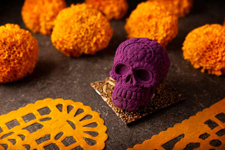 mexican skull made of chocolate. In Mexico culture named "calaverita de azucar" and Cempasuchil flowers or Marigold. Traditionally used in altars for the celebration of the day of the deathの写真素材