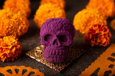 mexican skull made of chocolate. In Mexico culture named "calaverita de azucar" and Cempasuchil flowers or Marigold. Traditionally used in altars for the celebration of the day of the deathの写真素材