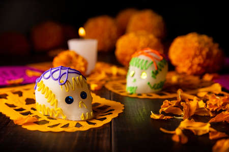 Sugar skulls with Candle, Cempasuchil flowers or Marigold and Papel Picado. Decoration traditionally used in altars for the celebration of the day of the dead in Mexicoの写真素材