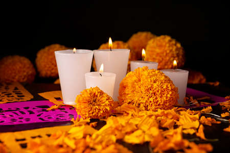 Candles with Cempasuchil orange flowers or Marigold. (Tagetes erecta) and Papel Picado. Decoration traditionally used in altars for the celebration of the day of the dead in Mexicoの写真素材