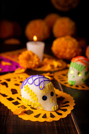 Sugar skulls with Candle, Cempasuchil flowers or Marigold and Papel Picado. Decoration traditionally used in altars for the celebration of the day of the dead in Mexicoの写真素材