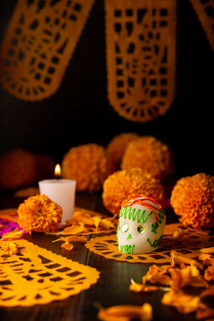 Sugar skull with Candle, Cempasuchil flowers or Marigold and Papel Picado. Decoration traditionally used in altars for the celebration of the day of the dead in Mexicoの写真素材