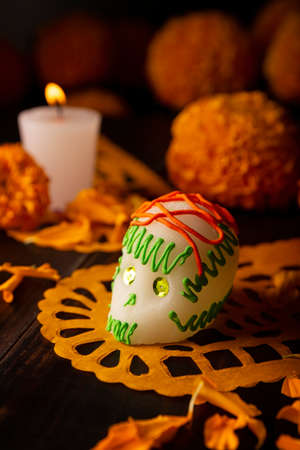 Sugar skull with Candle, Cempasuchil flowers or Marigold and Papel Picado. Decoration traditionally used in altars for the celebration of the day of the dead in Mexicoの写真素材
