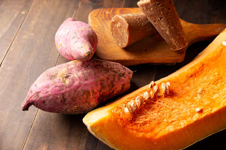 Pumpkin, Sweet potatos Camote and unprocessed sugar cane Piloncillo. Raw Ingredients for mexican traditional dessert for dia de muertos. Close up on rustic wooden tableの写真素材