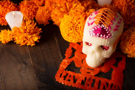 Sugar skull with Candles, Cempasuchil flowers or Marigold and Papel Picado. Decoration traditionally used in altars for the celebration of the day of the dead in Mexicoの写真素材