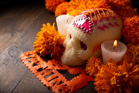 Sugar skull with Candles, Cempasuchil flowers or Marigold and Papel Picado. Decoration traditionally used in altars for the celebration of the day of the dead in Mexicoの写真素材