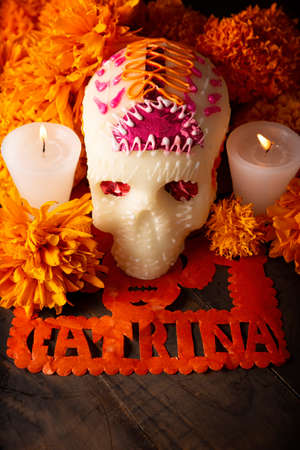 Sugar skull with Candles, Cempasuchil flowers or Marigold and Papel Picado. Decoration traditionally used in altars for the celebration of the day of the dead in Mexicoの写真素材