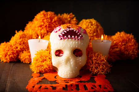 Sugar skull with Cempasuchil flowers or Marigold and Papel Picado. Decoration traditionally used in altars for the celebration of the day of the dead in Mexicoの写真素材