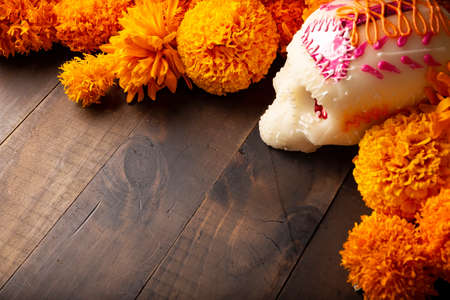 Sugar skull with Cempasuchil flowers or Marigold. Decoration traditionally used in altars for the celebration of the day of the dead in Mexicoの写真素材