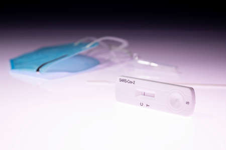 Rapid test device for   kit showing negative result. Lab card kit test for  SARS-CoV-2 virus. Fast test  on a lightboxの写真素材