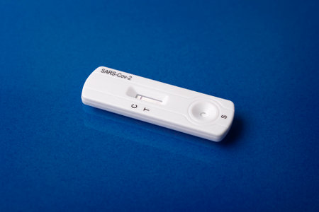 Close up image of Rapid test device for  showing negative result. Lab card kit test for virus SARS-CoV-2 virus. Fast test  on purple surfaceの写真素材