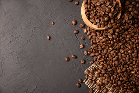 Organic toasted coffee beans on rustic black stone table with copy space for your text. top view imageの写真素材