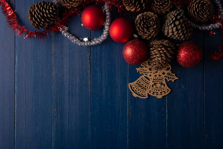 Pine cones and red christmas balls for christmas decoration on vintage blue wood background. Flat lay image with Copy space for your textの写真素材