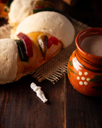 Traditional Kings day cake also called Rosca de Reyes, roscon, Epiphany Cake and with a clay Jarrito. Mexican tradition on January 5thの写真素材