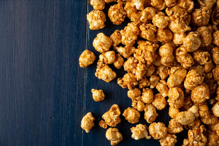 Heap of Caramel Corn Background on blue rustic tableの写真素材