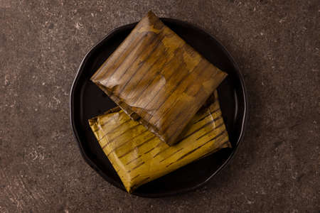 Prehispanic dish typical of Mexico and some Latin American countries. Corn dough wrapped in banana leaves. The tamales are steamed.の写真素材