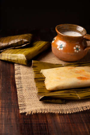 Prehispanic dish typical of Mexico and some Latin American countries. Corn dough wrapped in banana leaves. The tamales are steamed.の写真素材