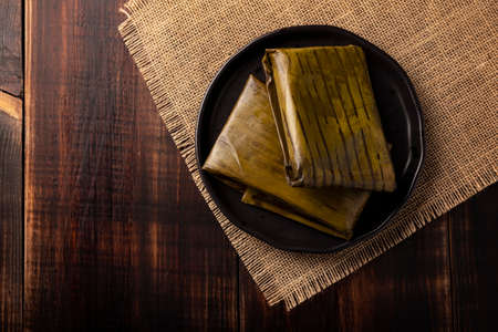 Prehispanic dish typical of Mexico and some Latin American countries. Corn dough wrapped in banana leaves. The tamales are steamed.の写真素材