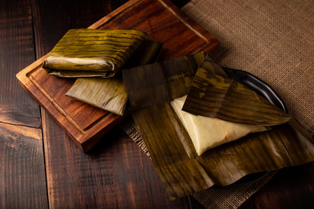 Prehispanic dish typical of Mexico and some Latin American countries. Corn dough wrapped in banana leaves. The tamales are steamed.の写真素材