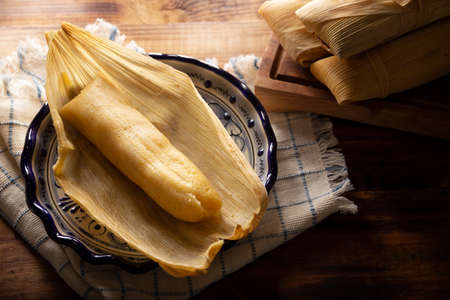 Prehispanic dish typical of Mexico and some Latin American countries. Corn dough wrapped in corn leaves. The tamales are steamed.の写真素材