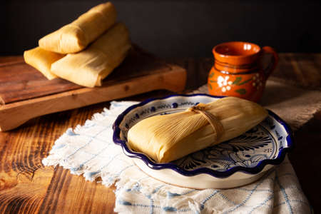 Prehispanic dish typical of Mexico and some Latin American countries. Corn dough wrapped in corn leaves. The tamales are steamed.の写真素材
