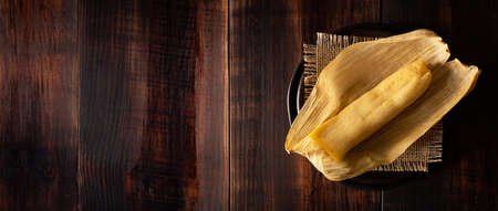 Tamales. Prehispanic dish typical of Mexico and some Latin American countries. Corn dough wrapped in corn leaves. The tamales are steamed.の写真素材