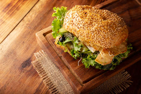 Healthy homemade sandwich with grilled chicken breast, lettuce, avocado, alfalfa germ and various...