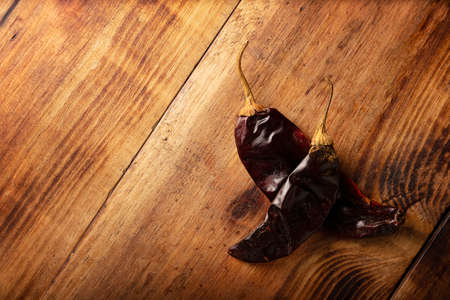 Guajillo chile. This Mexican chili is the dried form of mirasol chili and are used in a variety of Mexican preparations. Rustic wooden board. flat lay imagesの写真素材
