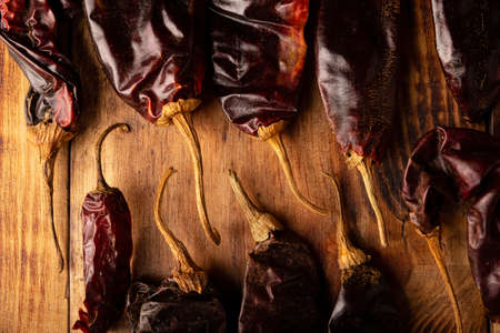 Guajillo chile. This Mexican chili is the dried form of mirasol chili and are used in a variety of Mexican preparations. Rustic wooden board. flat lay imagesの写真素材