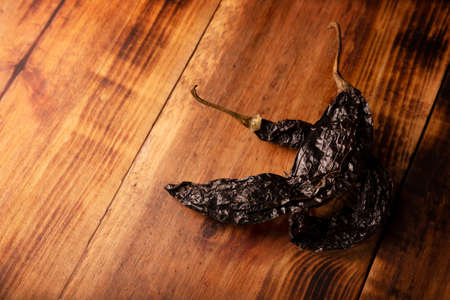 Pasilla. Also known as chile negro or chile prieto. This Mexican chili is the dried form chilaca chili and are used in a variety of Mexican preparations.の写真素材