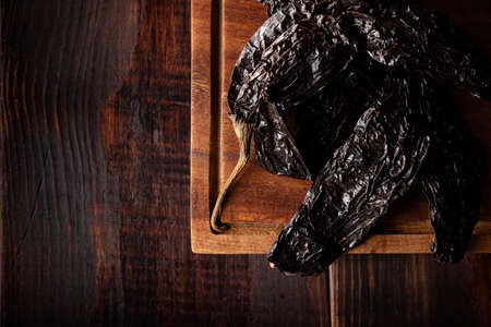 Pasilla. Also known as chile negro or chile prieto. This Mexican chili is the dried form chilaca chili and are used in a variety of Mexican preparations.の写真素材