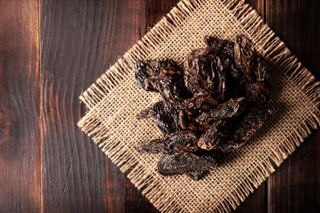 Morita chili. This Mexican chili is the dried and smoked form of jalapeÃ±o chili and are used in a variety of Mexican preparations. Flat lay.の写真素材