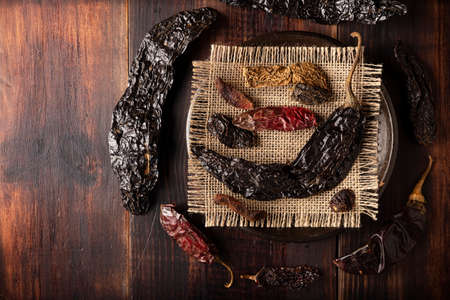 Variety of dried mexican chili. Chile Morita, Guajillo, sChipotle and Pasilla, This Mexican chili is the dried form chilaca chili and are used in a variety of Mexican preparations.の写真素材