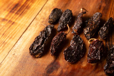 Morita chili. This Mexican chili is the dried and smoked form of jalapeÃ±o chili and are used in a variety of Mexican preparations. Copyspace.の写真素材