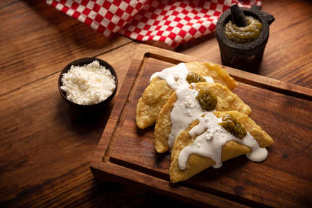 Fried quesadillas. Traditional Mexican appetizer "garnacha". Deep Fried handmade corn tortilla that can be filled with a wide variety of ingredients, cheese, pork rinds, meat, etc.の写真素材