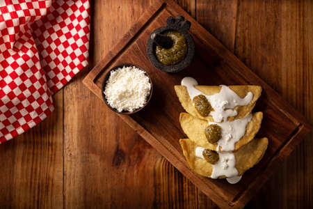 Fried quesadillas. Traditional Mexican appetizer "garnacha". Deep Fried handmade corn tortilla that can be filled with a wide variety of ingredients, cheese, pork rinds, meat, etc.の写真素材