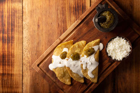 Fried quesadillas. Traditional Mexican appetizer "garnacha". Deep Fried handmade corn tortilla that can be filled with a wide variety of ingredients, cheese, pork rinds, meat, etc.の写真素材